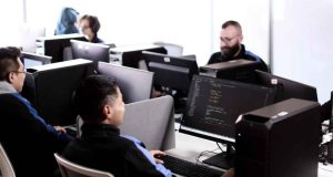 Jóvenes revisando la oferta de programas virtuales del SENA en un ordenador.